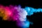 Freeze motion of colored powder explosions isolated on black background.Color dust particle splatter on background