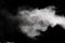 Freeze motion of white dust particles splash on black background.White powder explosion clouds