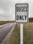 Freezing rain causing a buildup of ice on a bus sign outside a school