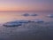 Freezing sea shore in the romantic evening light