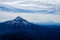 Freezy mountainous scenery covered in fog under the cloudy sky