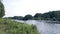 Freight boat on summer river. Cargo boat. Cargo ship floating along river