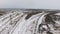 Freight, cargo train passing railroad station in winter. Aerial shoot.