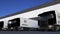 Freight semi trucks with Groupe Renault logo loading or unloading at warehouse dock. Editorial 3D rendering