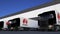 Freight semi trucks with Huawei logo loading or unloading at warehouse dock. Editorial 3D rendering