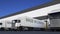 Freight semi trucks with MADE IN CANADA caption on the trailer loading or unloading. Road cargo transportation 3D