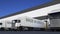 Freight semi trucks with MADE IN GREECE caption on the trailer loading or unloading. Road cargo transportation 3D