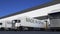 Freight semi trucks with MADE IN SPAIN caption on the trailer loading or unloading. Road cargo transportation 3D