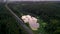 Freight train carries with coal an electric locomotive by two-sided railway in Ural swampy lake in the woods - Aerial Photography,