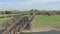 Freight Train Crossing an Iron Bridge Spanning a River