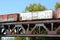 Freight Train Crossing a Steel Railroad Truss River Bridge