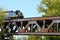 Freight Train Crossing a Steel Railroad Truss River Bridge