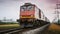 Freight train goes by rail. Fast delivery of heavy cargo by train. Blurred background gives a feeling of rapid movement.