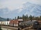 Freight train with graffiti passing through Jasper, Alberta, Canada. Rocky Mountains in background. Copy space.