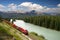 Freight train moving along Bow river in Canadian R