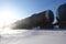 Freight train with oil tanks in motion. Snow dust flies from a passing train at high speed. Frosty sunny day. Winter. Russia