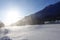 Freight train with oil tanks in motion. Snow dust flies from a passing train at high speed. Frosty sunny day. Winter. Russia