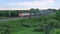 Freight train passing on a railroad track in the countryside