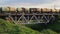 Freight train with petroleum tank cars passing over the railway bridge