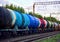 Freight train with petroleum tank cars on railroad. Rail cars carry oil and ethanol. Railway logistics explosive cargo.