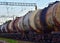 Freight train with petroleum tank cars on railroad. Rail cars carry oil and ethanol. Railway logistics explosive cargo.