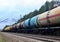 Freight train with petroleum tank cars on railroad. Rail cars carry oil and ethanol. Railway logistics explosive cargo.