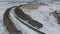 Freight train on the railway in winter. Gasoline, fuel tanks. Aerial shot.