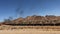 Freight train rides on railroad in desert. Sandy landscape in Africa, Namibia.