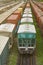 Freight train with tank wagons moving in forest. Green diesel cargo locomotive.