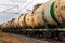 A freight train of tanks rushing by rail. Text in Russian: Transneft, oil transport, gasoline