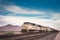 Freight train traveling Arizona desert.