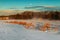 Freight train travels through the vast expanses of snow-covered