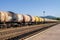 Freight trains.Railroad train of tanker cars transporting crude oil on the tracks