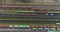 Freight trains stand at the railway junction top view. Fly over a large railway junction.