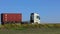 Freight transportation. The truck rides on a modern road. The truck drives along the highway in sunny weather. Truck on