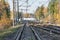 Freight truck crosses the railway line at autumn day