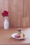 Frence sweet delicacy macaroons and red rose vase on grune wood table background