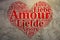 French: Amour. Heart shaped word cloud Love, grunge background