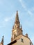 French architecture and cathedral spire against blue sky