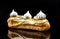 French Artisan Eclair on Black Reflective Background,Copy Space