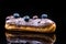 French Artisan Eclair on Black Reflective Background,Copy Space