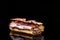 French Artisan Eclair on Black Reflective Background,Copy Space