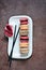 French assorted macarons cakes on a rectangular dish. Colorful Small French cakes.