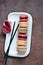 French assorted macarons cakes on a rectangular dish. Colorful Small French cakes.