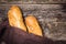 French baguette bread on old rustic wooden background. Crunchy freshly french bread. French bread sticks freshly out of the oven