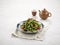 French Bean with Minced Pork and Dried Chilli in a dish isolated on napkin side view on grey background