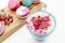 French beautiful macarons on wood desk and blue cup of aroma cappuccino