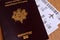 French biometric passport with a plane ticket in it close up