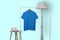 French blue polo shirt hanging on rack display isolated on plain background