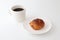 French bread pain au chocolat chocolate croissant on plate with cup of coffee on white background